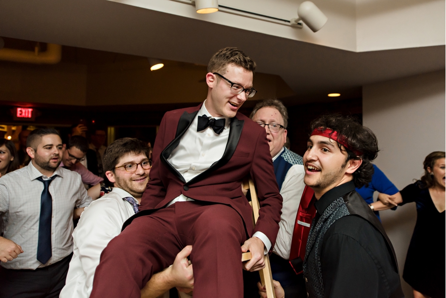 A groom during a chair lift at a jewish wedding reception in Philadelphia.